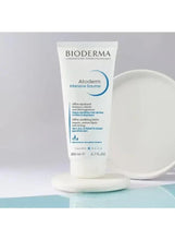 Atoderm Intensive balm tube beside a rounded cream dollop, front and side view