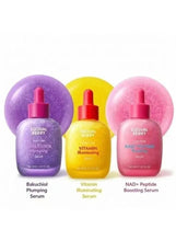 Three face serum bottles: Bakuchiol purple, Vitamin illuminating yellow, NAD+ peptide pink
