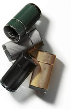 Three textured fragrance bottles with dark green, black, and gold caps