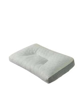 Quilted latex pillow with cutout top and gray base sides, white cover.