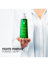 Vichy Normaderm purifying cleanser bottle held by clinician, fights pimples