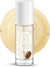 BAKE lip oil bottle close-up in clear glass with white cap and coffee bean detail