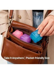 Pocket-sized sensory cube stress toys in pink, purple, and blue inside a bag