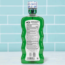 ACT anticavity fluoride rinse bottle with green label and screw cap