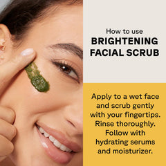 Woman applying Acure brightening facial scrub to her cheek with fingertip demonstrating usage