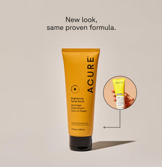 Acure brightening facial scrub tube in yellow with black cap showing new and old packaging side by side