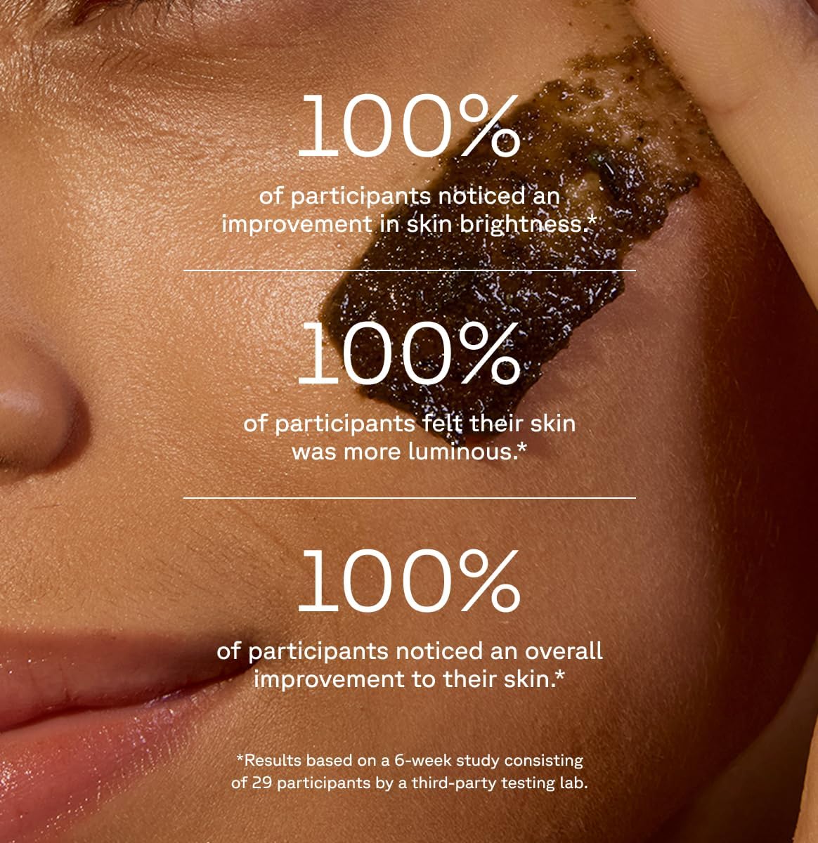 Close-up of face with Acure brightening facial scrub applied on cheek showing skin brightening benefits