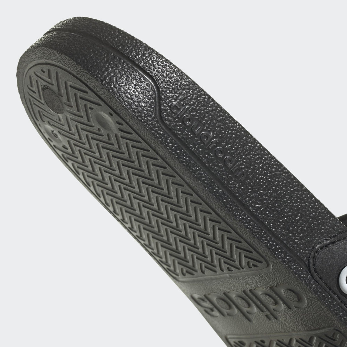 Black Adidas pool slippers for men and women with textured sole for grip and comfort