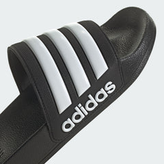 Black adidas pool slippers for men and women with white brand stripes and logo