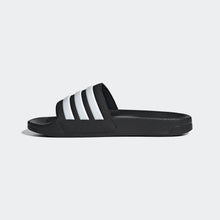 Black slip-on pool slide sandal with three white adidas stripes across the strap