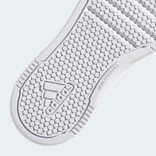 Kids adidas sneaker outsole detail with textured grip dots and branding on the tread.