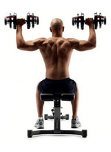 Adjustable dumbbell in each hand, stacked black plates with red dial accents