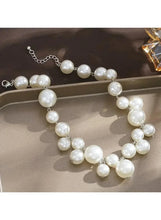Adjustable pearl necklace with long strand of round white pearls and silver-tone chain