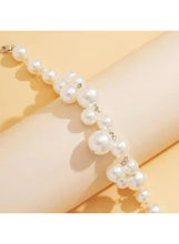 Close-up pearl necklace with small round white beads and silver-tone chain links