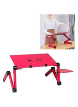 Portable folding laptop table with pink top, black legs, and vent fan holes