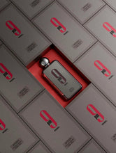 Perfume bottles lined in a grid with black caps and red labels