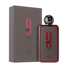 Afnan 9 PM Rebel perfume bottle with dark gray and red design next to matching box packaging