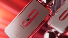 Afnan 9 PM Rebel perfume bottle with sleek red and silver design on reflective surface