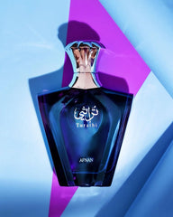 Afnan Turathi Blue perfume for men in a blue glass bottle with silver cap on geometric background
