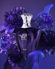 Afnan Turathi Blue perfume for men bottle surrounded by purple flowers on a dark background