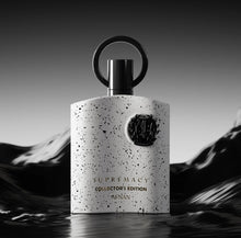 Perfume bottle centered with speckled light-gray body, black emblem and loop cap
