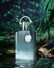 Unisex eau de parfum bottle, blue-gray finish with silver cap ring and crest logo.