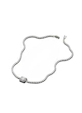 Silver-tone crystal necklace with rectangular center pendant and curved chain links