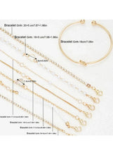 Assorted gold-tone chain bracelets with pearl beads and an open bangle cuff