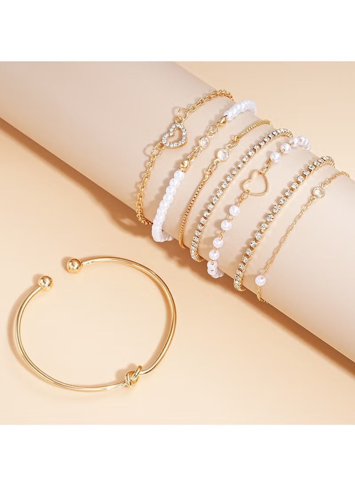 Huitich 8 piece alloy bracelet set featuring gold and white beaded designs with heart charms