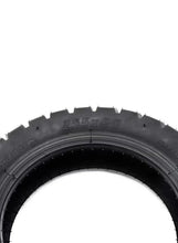 Black scooter tire sidewall and tread blocks, close-up