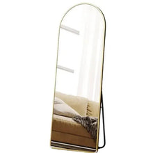 Gold arched standing mirror with thin metal frame, full-length reflective glass