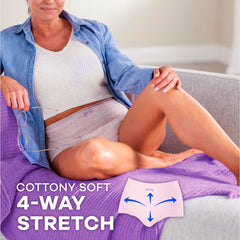 Always Discreet woman reclining on couch wearing light cottony disposable postpartum underwear for women with four way stretch