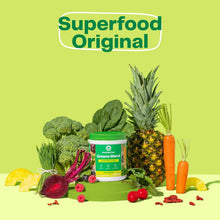 Greens Blend supplement jar with surrounding superfood vegetables