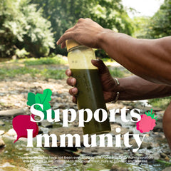 Amazing Grass green superfood powder UAE smoothie bottle being held outdoors by a person supporting immunity
