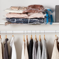 Amazon Basics vacuum bags 5 pack storing folded clothes vacuum-sealed on closet shelf