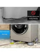 Washing machine on gray anti-vibration pads with thick rubber feet