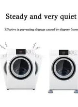 Two washing machines on gray anti-vibration pads, showing front circular feet