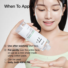 Woman holding Anua Heartleaf 77 Soothing Toner bottle while applying toner on hand