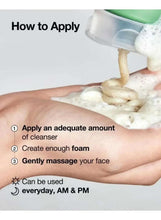 Cleansing foam being poured onto hands with bubbles, tube shown at top