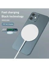 Gray phone with white circular magnetic charging pad and charging cable