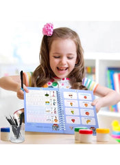Young girl happily reading Arabic magic practice books for kids by Huitich with colorful illustrations