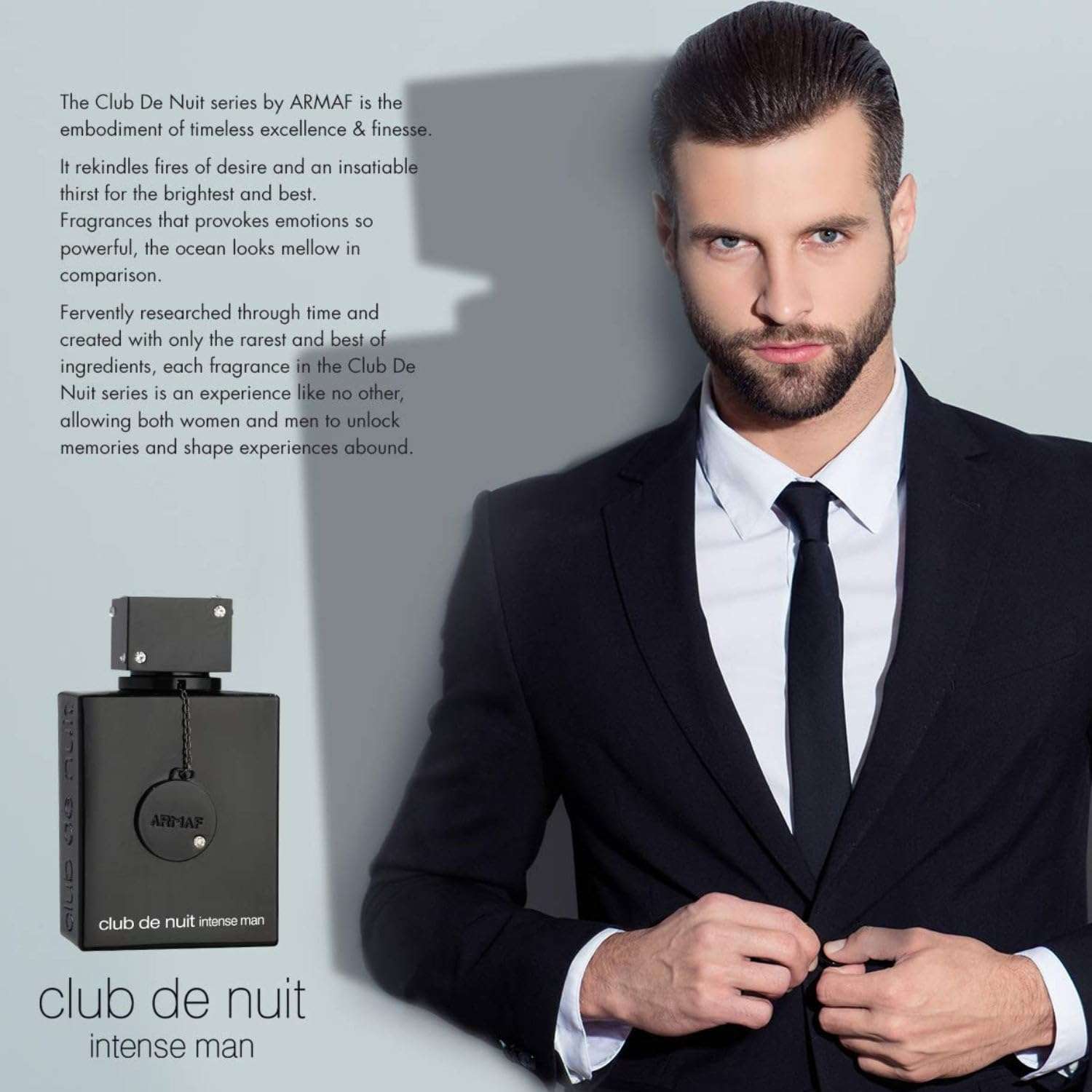 Armaf Club de Nuit Intense Man black perfume bottle next to a man in a black suit adjusting his jacket