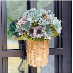 Huitich artificial blue daisy flowers arranged in a woven basket hanging on a window frame