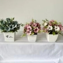 Artificial flower bonsai set in white pots, blue and pink blossoms