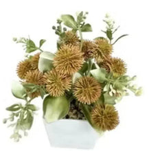 Artificial brown rose bouquet in white vase with green leaves and flower heads