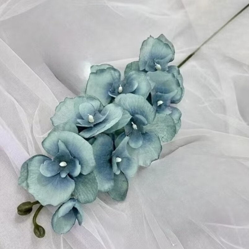 Huitich artificial flower decor pack featuring blue artificial flowers on a delicate white fabric