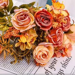 Huitich artificial mini rose flower bunch with peach and orange blooms and green leaves on text background