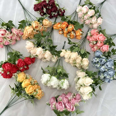 Huitich artificial orange flower arrangement and mixed color artificial flowers with green leaves on white fabric