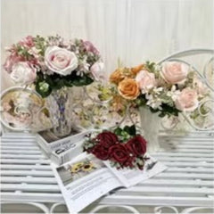 Huitich artificial orange flower decor arranged in a vase with mixed floral bouquets on a white table