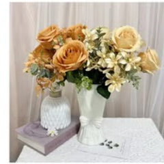 Huitich artificial orange flower decor arranged in white vases on a table with a book and curtain background